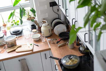 A mess in the kitchen, dirty dishes on the table, scattered things, unsanitary conditions. kitchen...
