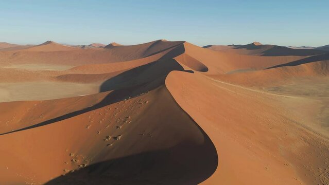 Aerial top view of Namib Desert Safari with sand dune in Namibia, South Africa. Natural landscape background at sunset. Famous tourist attraction. Sand in Grand Canyon