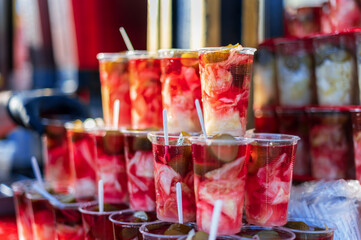 Cups with turshi displayed on a shop window