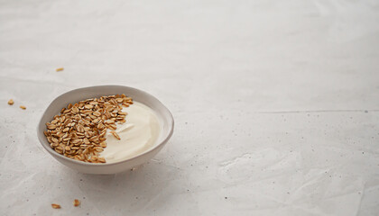 yogurt with oatmeal in a round plate. healthy breakfast rich in minerals and fiber