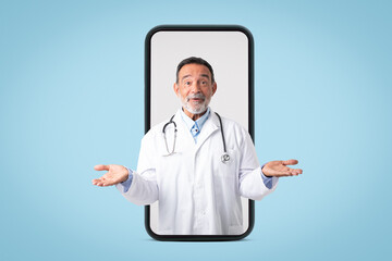 Happy funny caucasian senior doctor therapist in white coat hold empty space in hands on big phone screen