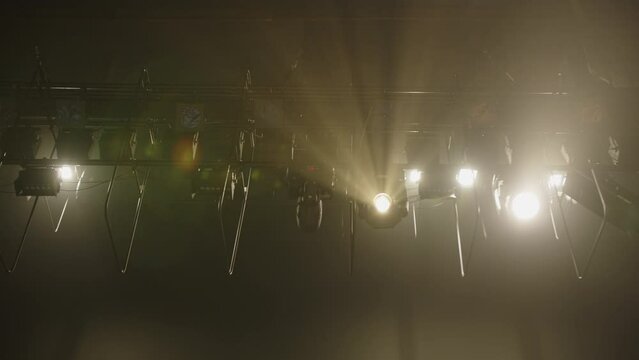 rays of stage light in the smoke