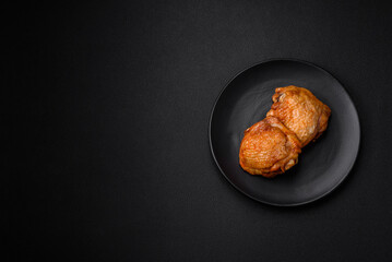 Delicious juicy chicken thighs baked with salt, spices and herbs in a ceramic plate