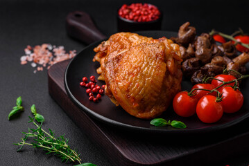 Delicious juicy chicken thighs baked with salt, spices and herbs in a ceramic plate