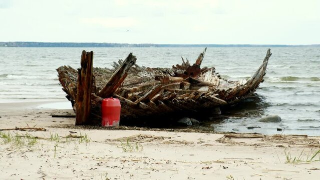 Abandoned shipwreck, An abandoned broken boat full of holes lying on the seashore. Wreck ship on reefs in sea or ocean. The sunken ship, the ship ran aground. Ecological disaster of the Aral Sea.