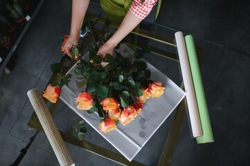Female florist making beautiful bouquet at flower shop