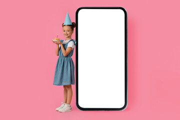 Cute Little Girl With Birthday Cake Standing Near Big Blank Smartphone