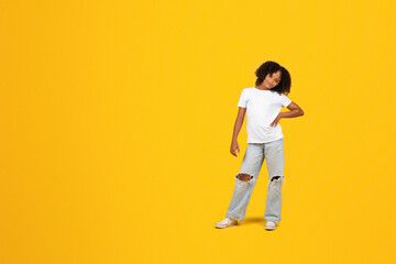 Happy confident curly teenager black schoolgirl in white t-shirt look at camera