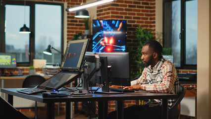 African american web developer working in artistic office to create CGI content on 3d software,...