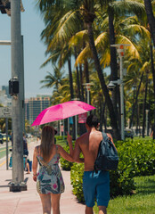 couple walking on the street sun Miami Beach 