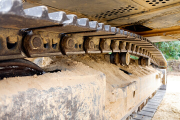 Underside of the iron tracks of an excavator.