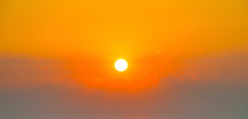 Sunset over fields and trees in a green hilly landscape under a colorful sky in sunlight in spring, Voeren, Limburg, Belgium, June, 2023