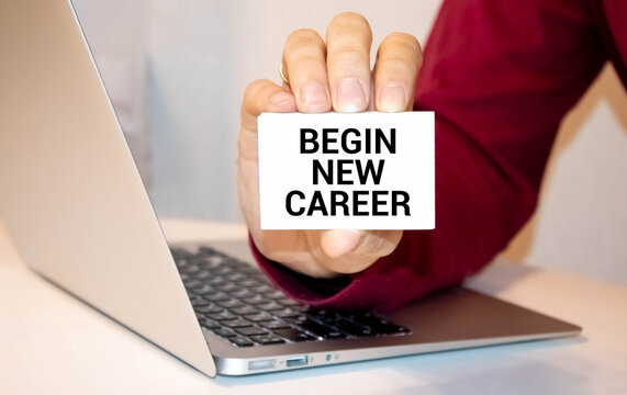 On the table there are paper clips and directional arrows, a sign that says - Begin New Career