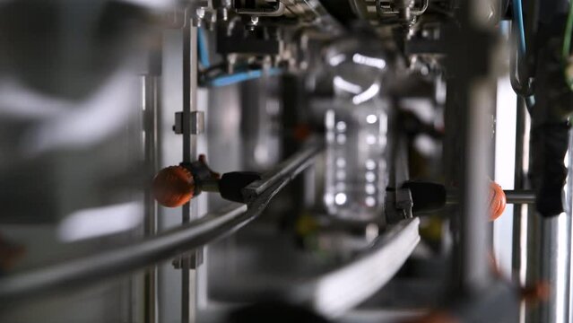 Production of plastic bottles. Plastic containers moving through the pipeline.