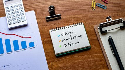 There is notebook with the word Chief Marketing Officer. It is as an eye-catching image.