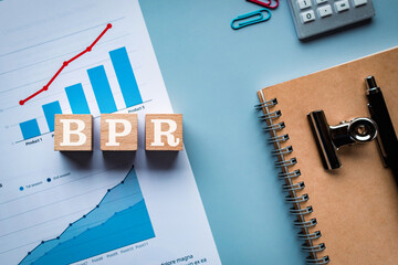 There is wood cube with the word BPR. It is an abbreviation for Business Process Re-engineering as...