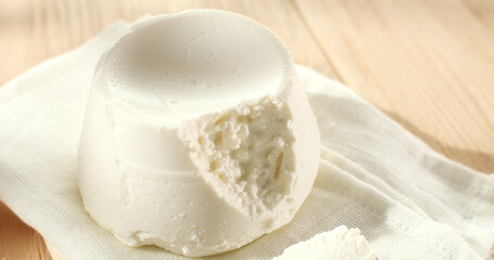 ricotta cheese. traditional italian cheese on a white napkin. ingredients for tortellini or tortelloni pasta. visual recipe. sunny day. angle view. macroshot.