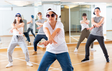 Happy girls and boy dancing hip hop in dancing class