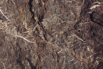 Texture cracked rock formation rock in the wild. Rocky cliff. Abstract Stone texture. Steep cliff of high mountain. Nature background, geological structure. Marble rocks in the wild. Detail Of Granite