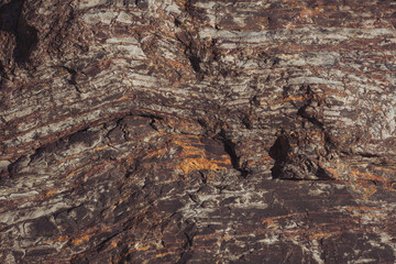 Texture cracked rock formation rock in the wild. Rocky cliff. Abstract Stone texture. Steep cliff of high mountain. Nature background, geological structure. Marble rocks in the wild. Detail Of Granite