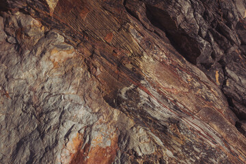 Texture cracked rock formation rock in the wild. Rocky cliff. Abstract Stone texture. Steep cliff of high mountain. Nature background, geological structure. Marble rocks in the wild. Detail Of Granite
