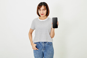 Cute asian short brunette hair woman promotes smartphone app mockup of blank screen, woman blogger showing personal social media page hold phone look camera happily smiling on white background
