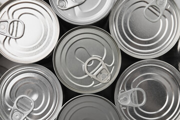 Many closed tin cans as background, top view