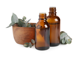 Bottles of eucalyptus essential oil and bowl with plant branches on white background