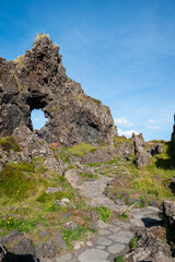 Fototapeta premium Stone path at Djúpalónssandur black sand beach on a sunny day, Iceland