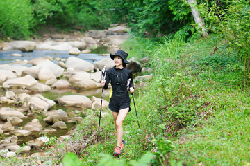 Selective focus Asian woman exercising, running, trail running in the midst of nature.