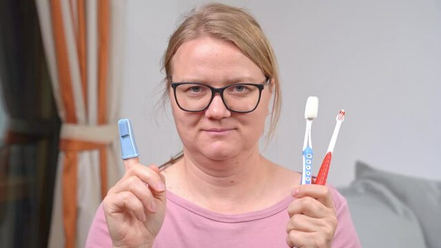 Set of toothbrushes in hands of dentist, selection, differences, expert advice on benefits of rubber. Morning tooth brushing, oral hygiene, caries protection. Mother calls children to brush teeth 