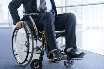 Businessman in a suit riding in a wheelchair no-face