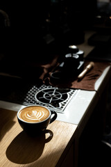 Fototapeta na wymiar Cup of coffee with latte art on the wooden table.