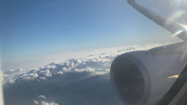 Sun, hills, fluffy clouds - plane view