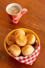 Cheese bread (Brazilian pao de queijo mineiro), front view, focused, coffee cup