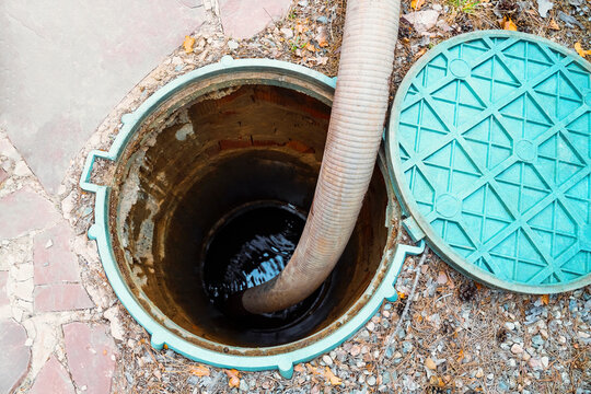 Pipe in the drainage pit. Pumping out sewage from a septic tank. Septic tank service