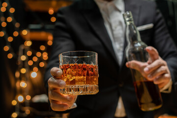 Barman pouring whiskey whiskey glass..