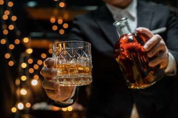 Barman pouring whiskey whiskey glass..