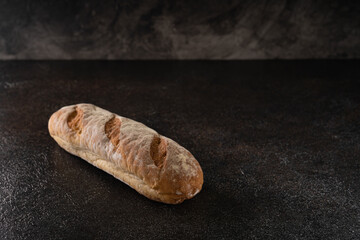 Fresh homemade artisan loaf of baguette breads on rustic background with copy space. sourdough mini baguette breads.