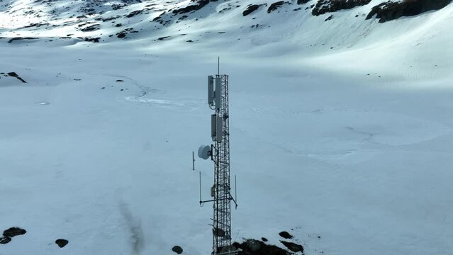 Critical communication infrastructure - Aerial slowly rotating around a mast filled with communication equipment for cellphones and emergency tetra networks and more - Strynefjellet Norway