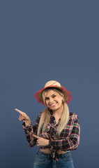 Beautiful brazilian woman, with festa junina clothes, on blue background.
