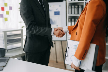 Two confident business man shaking hands during a meeting in the office, success, dealing, greeting and partner