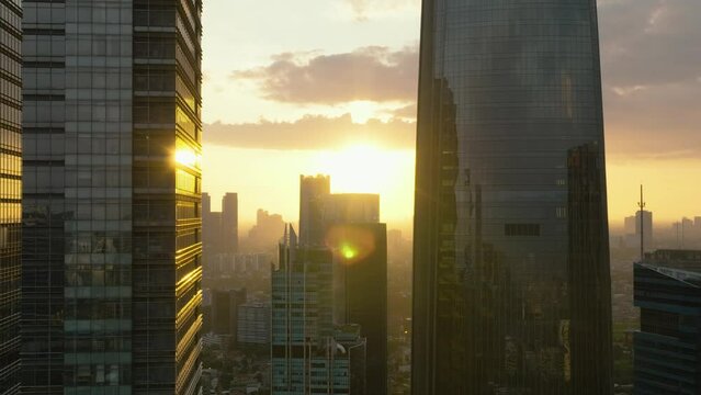 Aerial view of Jakarta city and skyscrapers at sunset. Indonesia. Urban landscape.
