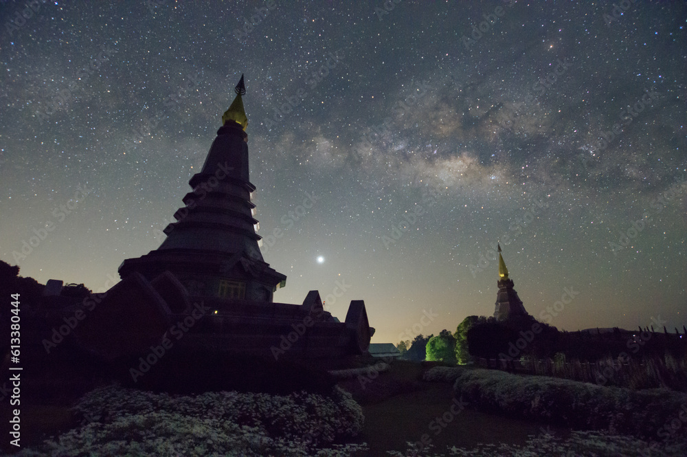 Wall mural spectacular milky way over a sacred temple at doi inthanon national park, chiang mai, thailand.