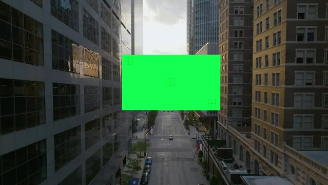 Drone moving toward a Chroma key screen in middle of city high-rise - 3D render