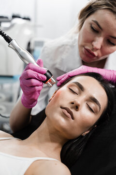 Thermal or radio frequency hardware RF lifting. Tightening and rejuvenation of facial skin of girl at cosmetology procedure.