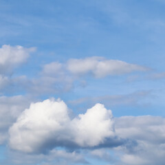 Naklejka na ściany i meble Background of blue sky with white clouds