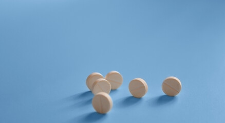 banner, background for a medical website or article, pills rolling on a blue background, medicines, medical care