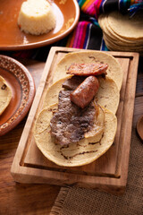 Taco campechano style, Carne Asada. (roast meat) and chorizo or longaniza, very popular dish in northern Mexico, also called Asado, Discada or Parrillada.