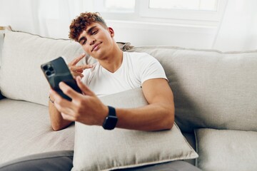 man interior blogger male text message adult lifestyle selfies couch sports cyberspace modern sofa